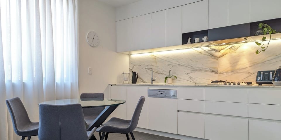 A well-arranged kitchen area paired with a stylish, modern dining set.