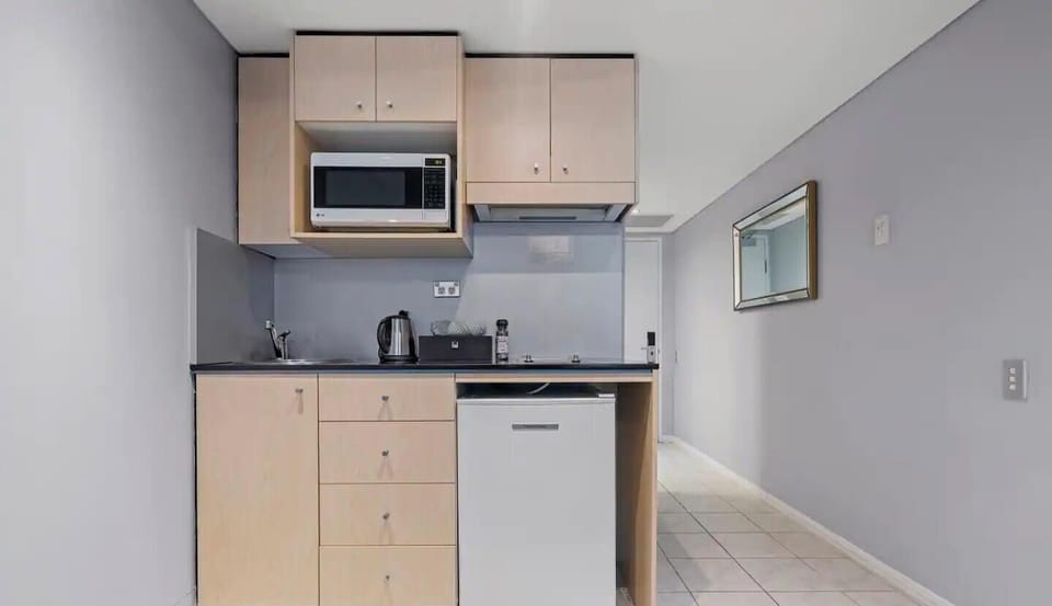 Clean kitchen area with convenient appliances