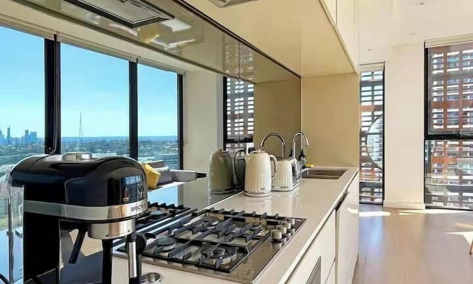 A close-up of a kitchen counter showcasing a coffee machine and stovetop.