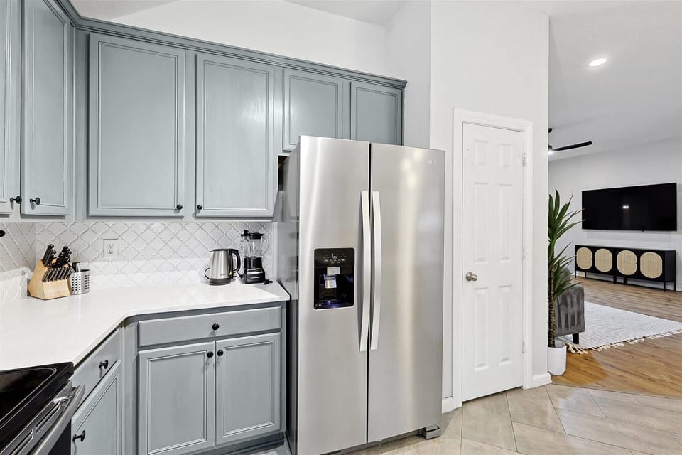 Beautiful kitchen with a large refrigerator and all the necessary utensils for cooking