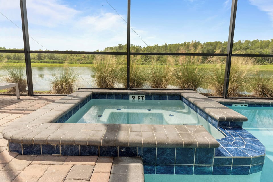 Unwind in the bubbling hot tub surrounded by sleek blue tiles and enjoy serene views of nature. The spacious patio is ideal for relaxing after a day of exploring, creating a calming atmosphere for you to savor every moment.