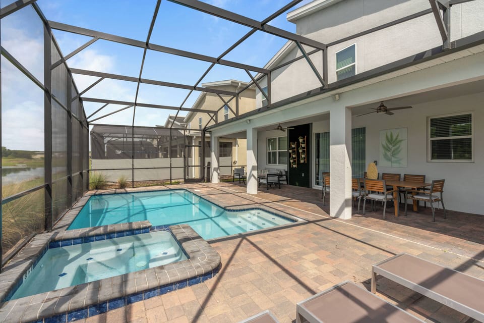 Step outside to your private oasis with a sparkling pool and spa surrounded by serene landscaping. Relax on the spacious patio, featuring elegant outdoor dining and a charming ambiance, perfect for soaking up the sun.