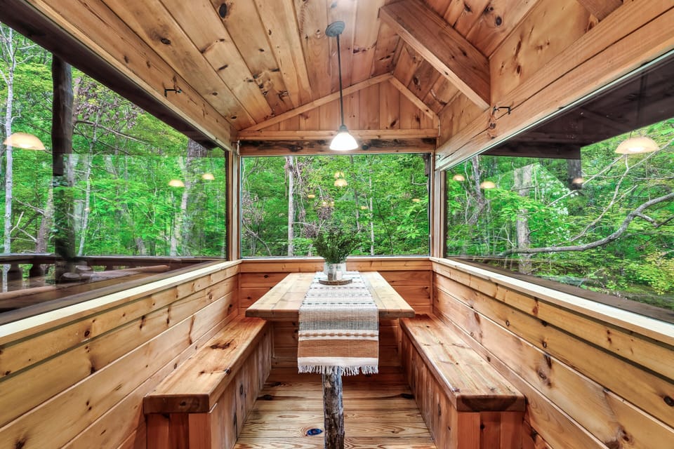 Breakfast nook for dining surrounded by views of trees and completely private
