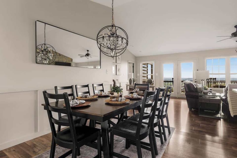 Formal dining table seating 8 with chandelier and valley view