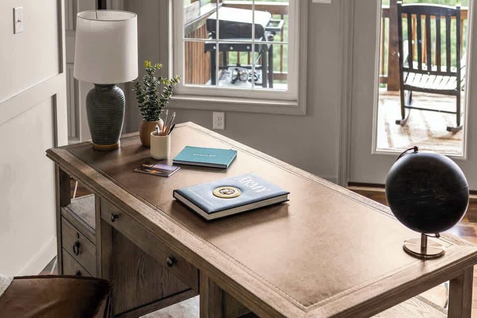 Workspace with desk, lamp, and view to the deck