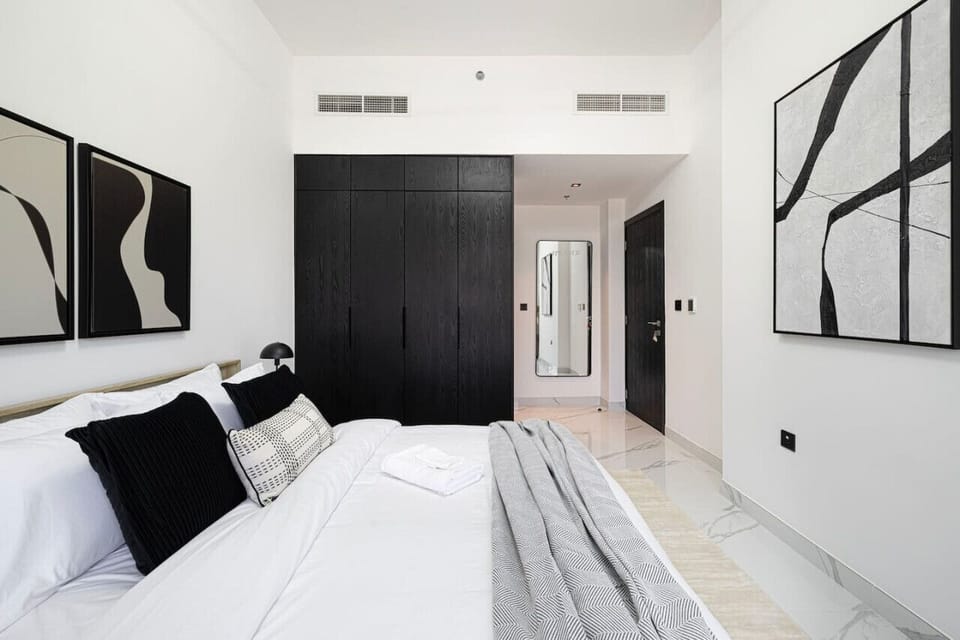 Another angle of the bedroom with a comfy bed and closet