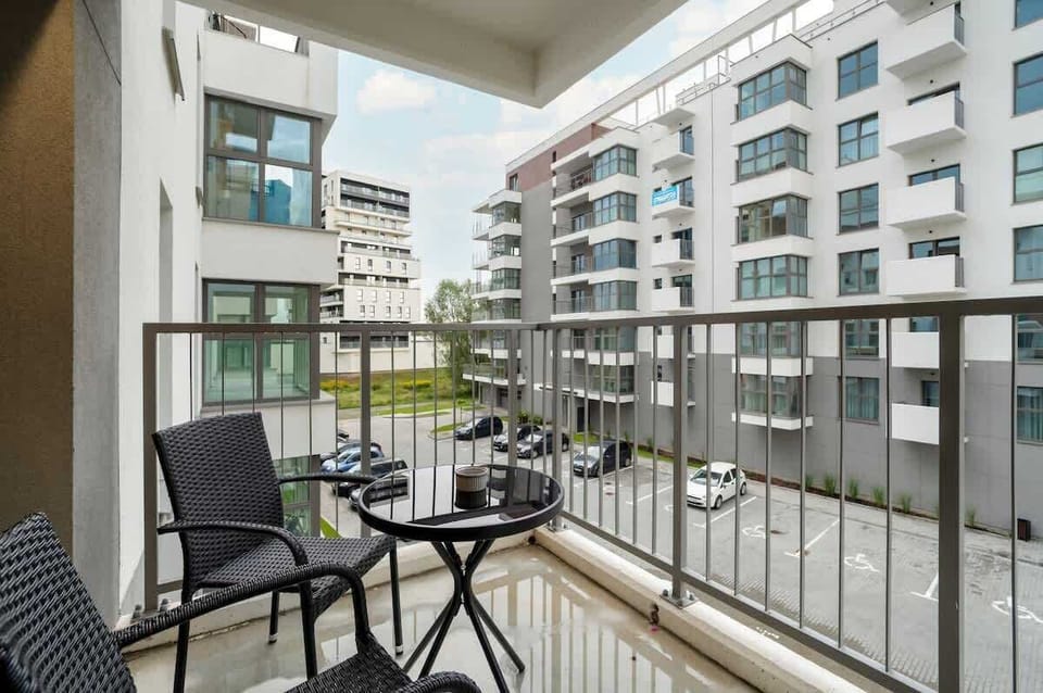 A welcoming balcony with outdoor seating, perfect for enjoying fresh air and city views.