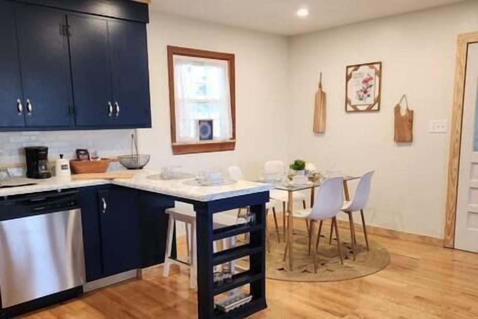 Kitchen Breakfast Island, Dining Area, and Entrance to Owner's Suite