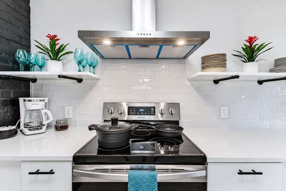 Modern chef’s kitchen with sleek finishes and bright open shelving