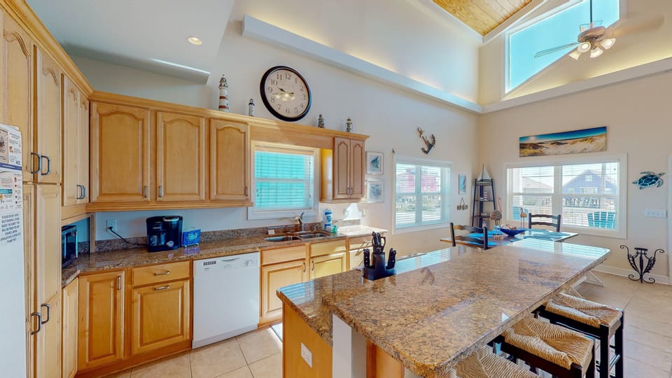 The kitchen island stands in the center of the open living space, serving as the hub around which all your new memories will be made.