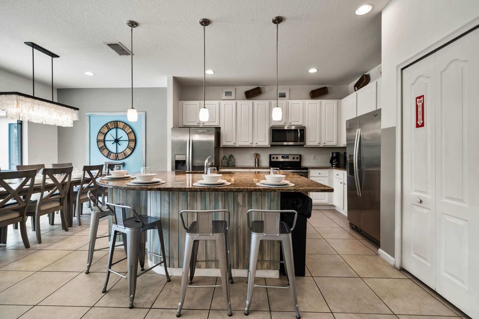 - Modern kitchen with granite counters and stainless steel appliances  
- Spacious island with bar seating perfect for family vacation meals  
- Fully equipped setup makes this Orlando rental feel like home