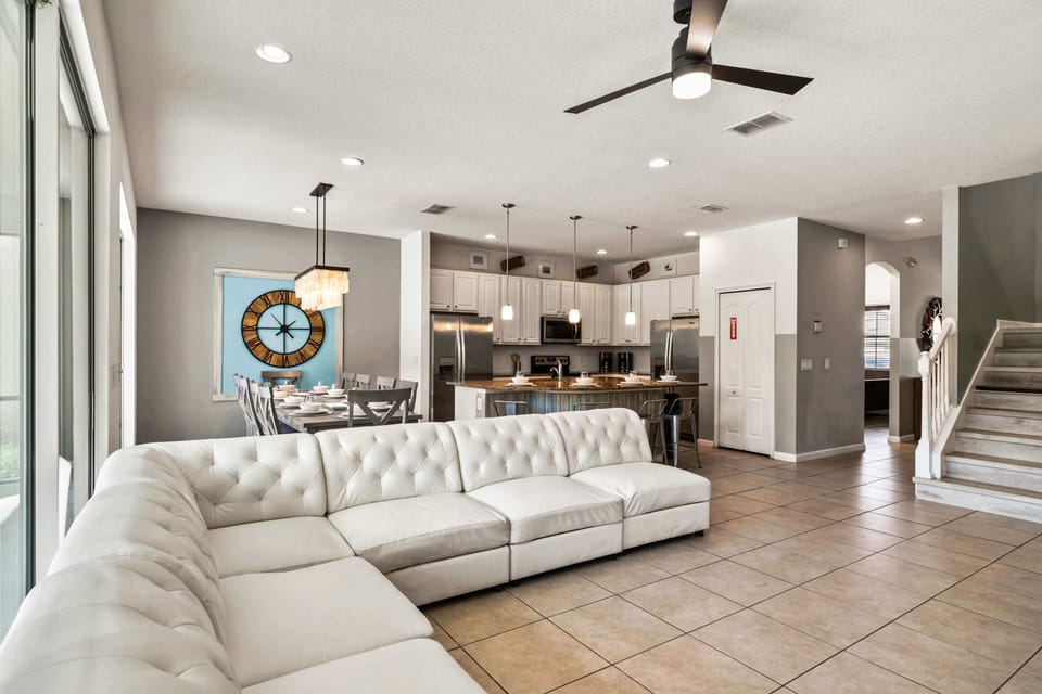 - Bright open living area with large sectional sofa and poolside views  
- Modern kitchen fully equipped with stainless steel appliances  
- Dining space accommodates group meals in a welcoming layout
