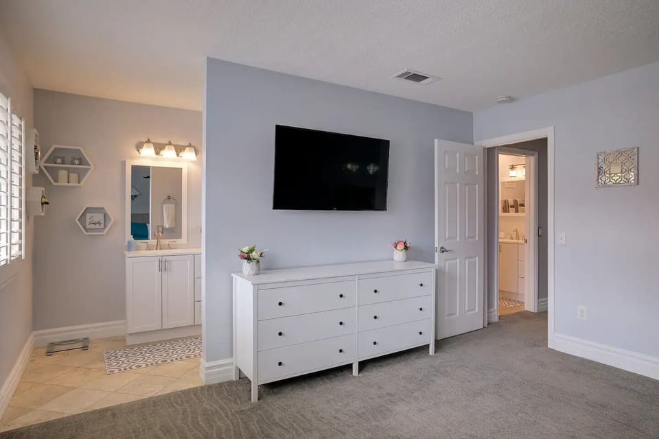 50" Roku TV in master bedroom with full bathroom.