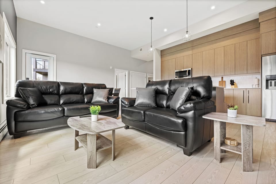 Comfy living room with leather couches, perfect for relaxing after a day long day of exploring!