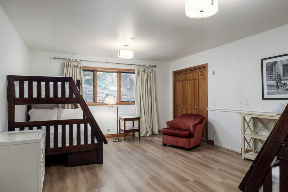 Breathe in natural light from large windows while relaxing in this comfy bunk room