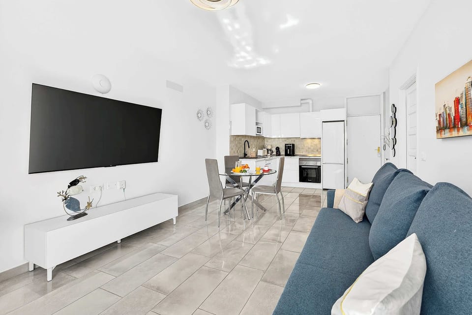 Livingroom with Dining Table, Sofa Bed, Flatscreen TV, and Balcony View