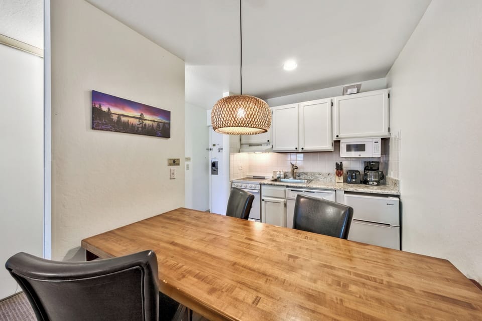 Gather around your spacious dining table for memorable meals, with a fully equipped kitchen featuring granite counters and modern appliances.