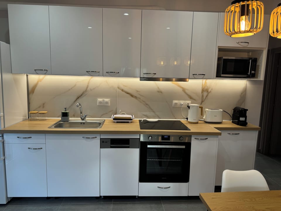 Kitchen with all amenities and dining table.