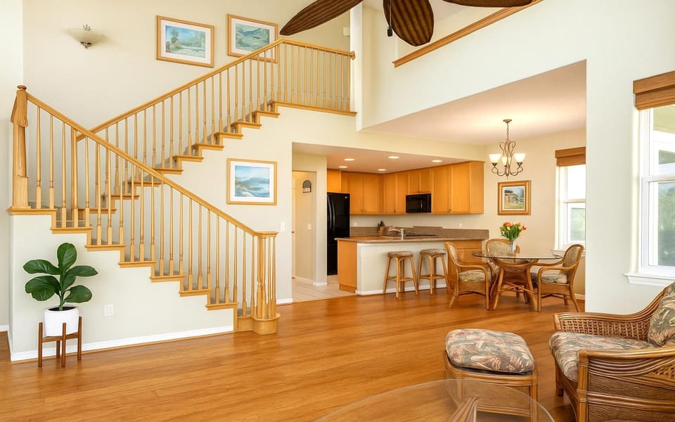Beautiful hardwood floors and staircase elevate the warmth of this island getaway    