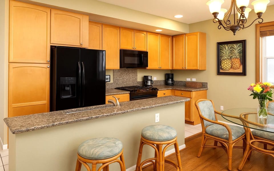 Enjoy morning coffee or evening wine at the bar of this beautiful granite kitchen    