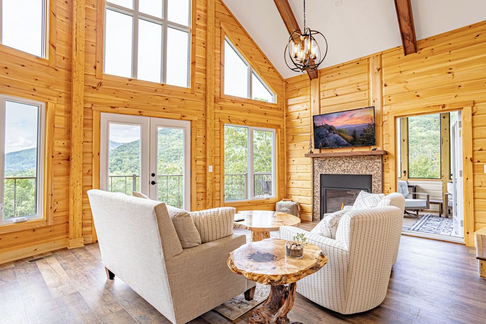 The main living room has a loveseat, two glider swivel chairs and a poof seat.