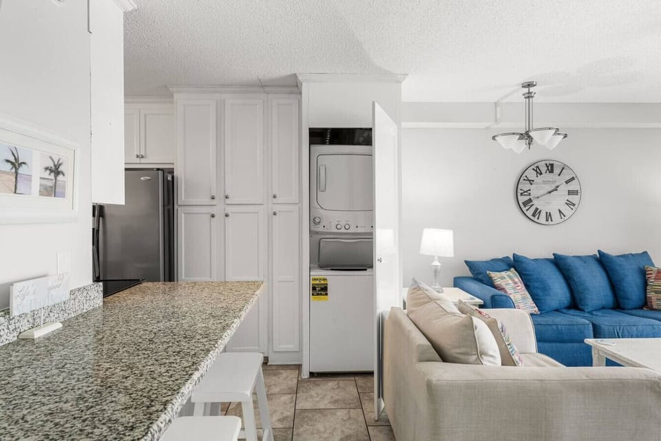 Stackable washer/dryer beside the Kitchen