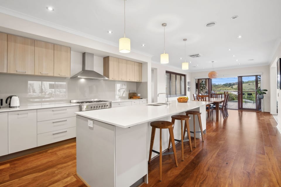 The kitchen is a chef’s delight, with extensive storage, a walk-in pantry, and ample counter space