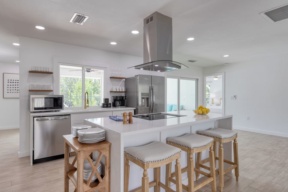 Fully equipped kitchen with barstool seating.