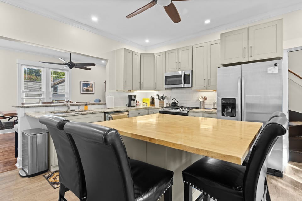 KITCHEN:  The home has a newly-renovated kitchen with a large kitchen island and all appliances, including a dishwasher.  There is also a good supply of cooking and dining utensils provided.
