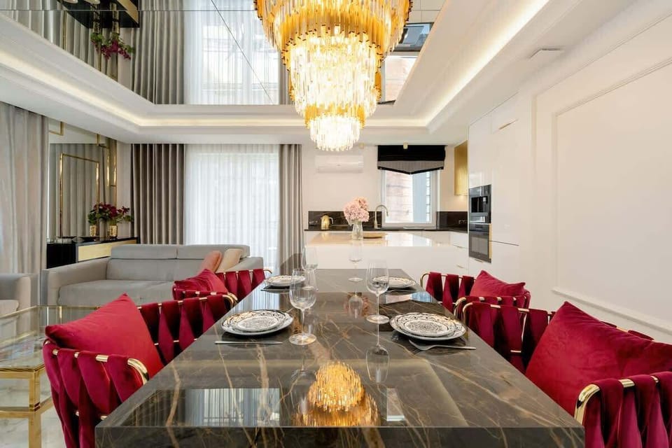 The dining area with a large table and designer red chairs is ideal for communal meals.