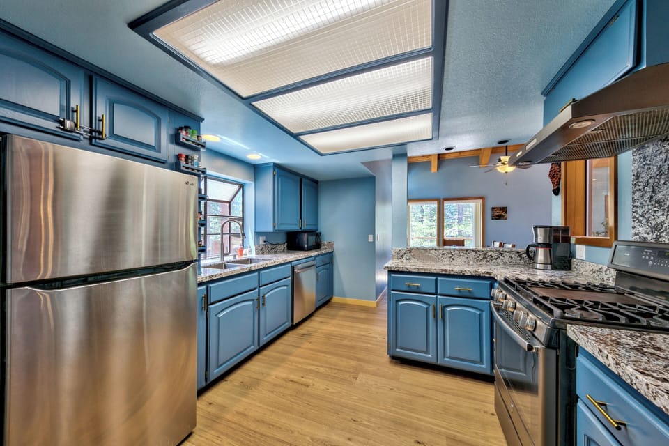 Your spacious kitchen awaits with granite countertops, stainless steel appliances, and abundant natural light streaming through the skylight overhead.