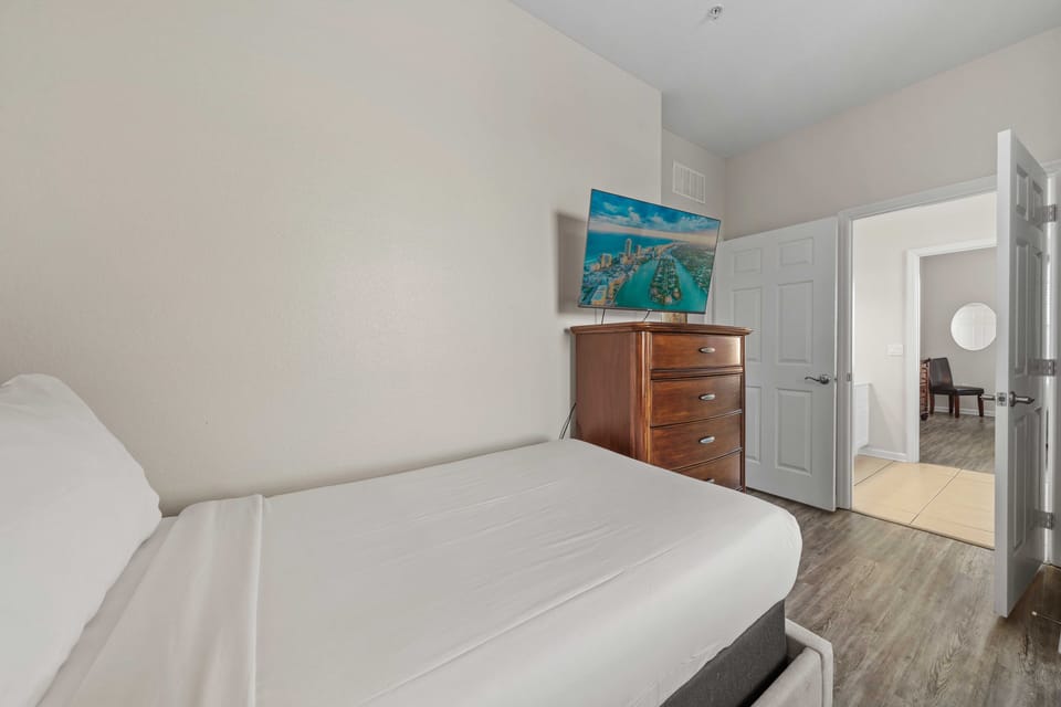 - Charming  bedroom with a comfortable twin beds along with attach private bathroom - Equipped with a wooden dresser and a smart TV for relaxation - Room has easy access to the adjacent areas making it convenient and well-connected within the home