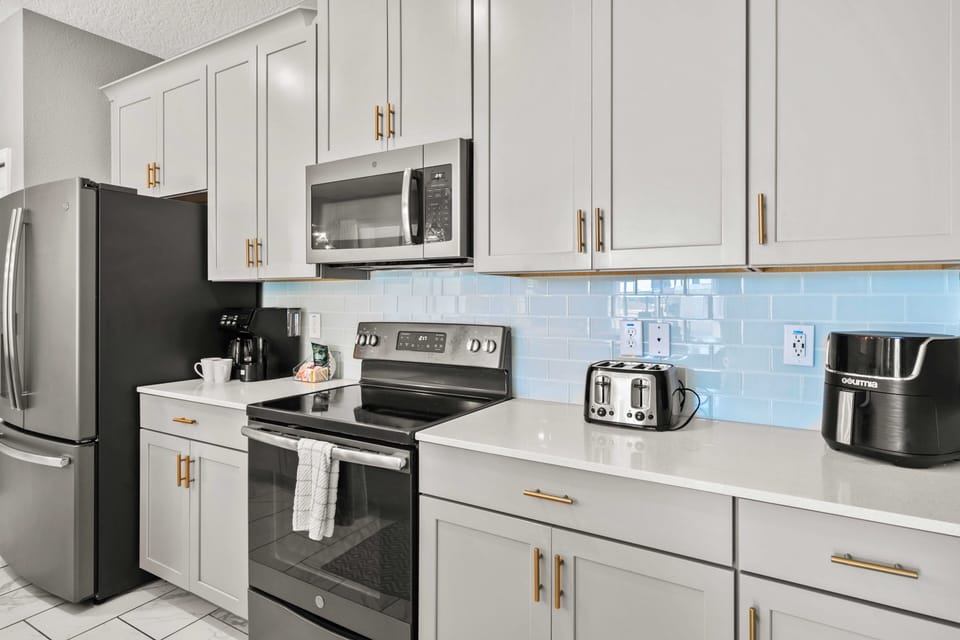 - Sleek and modern kitchen equipped with top-of-the-line appliances and stylish cabinetry - Prepare meals with ease in this bright, functional, and beautifully designed space - The perfect blend of elegance and practicality for culinary creativity