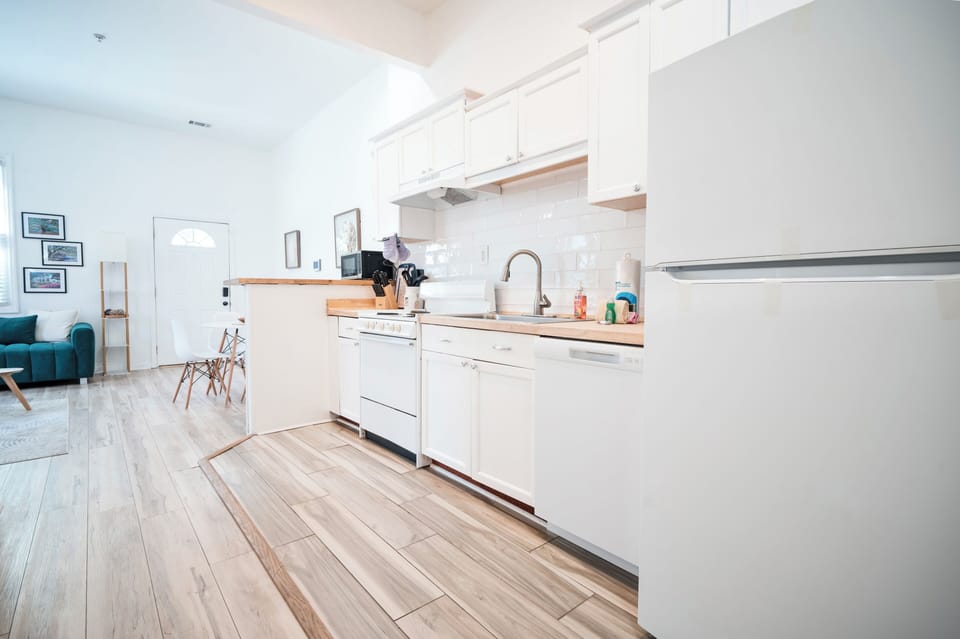 Full kitchen with fridge, dishwasher, oven, microwave, stove and coffee machine