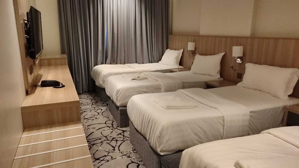 Basic Quadruple Room | In-room safe, desk, laptop workspace, blackout drapes