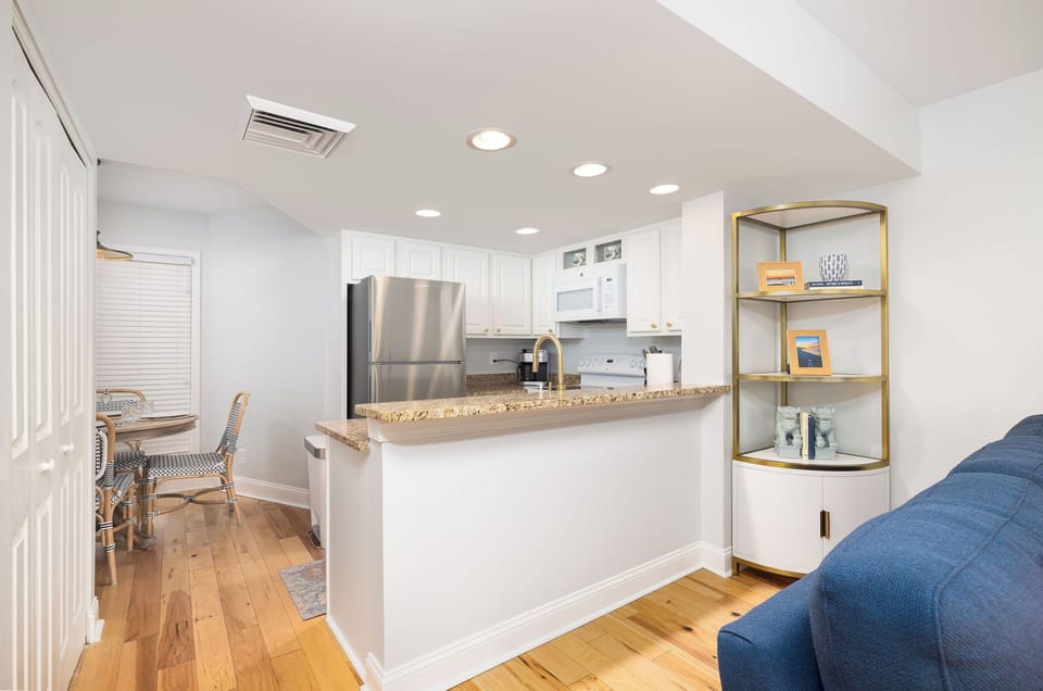 Airy Kitchen highlighting updated finishes, fully equipped kitchen — steps from the beach
