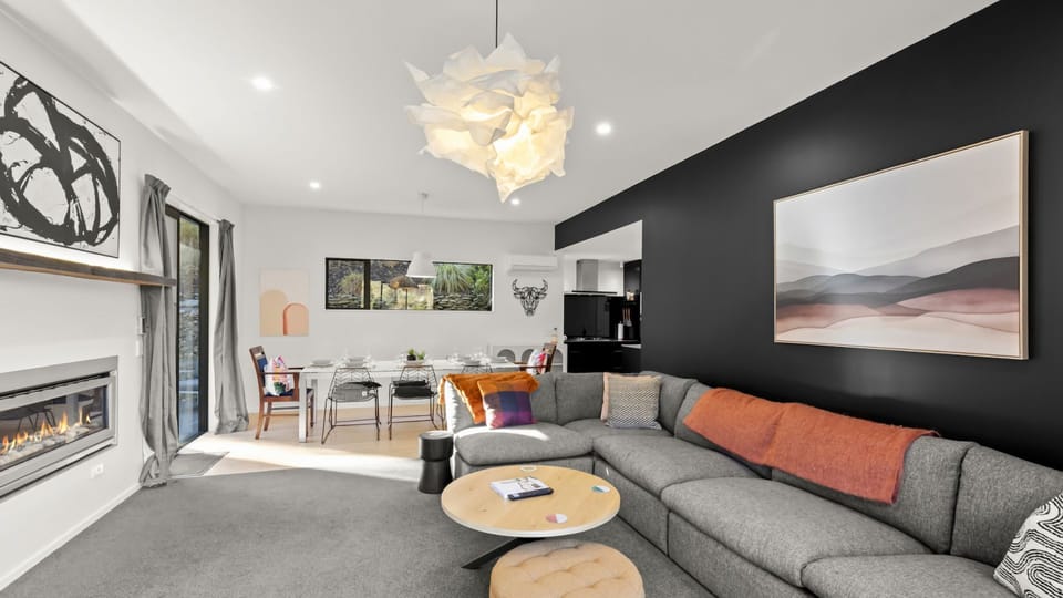 Open plan living with gas fireplace and heatpump