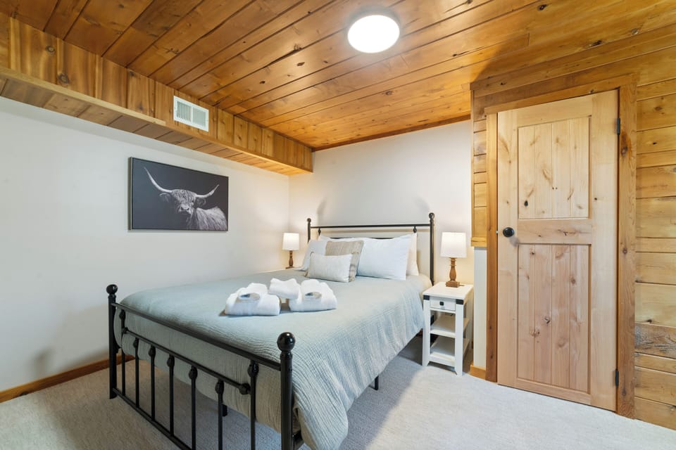 This bedroom offers a queen bed, room darkening curtains, walk in closet, dresser and close proximity to the main bathroom
