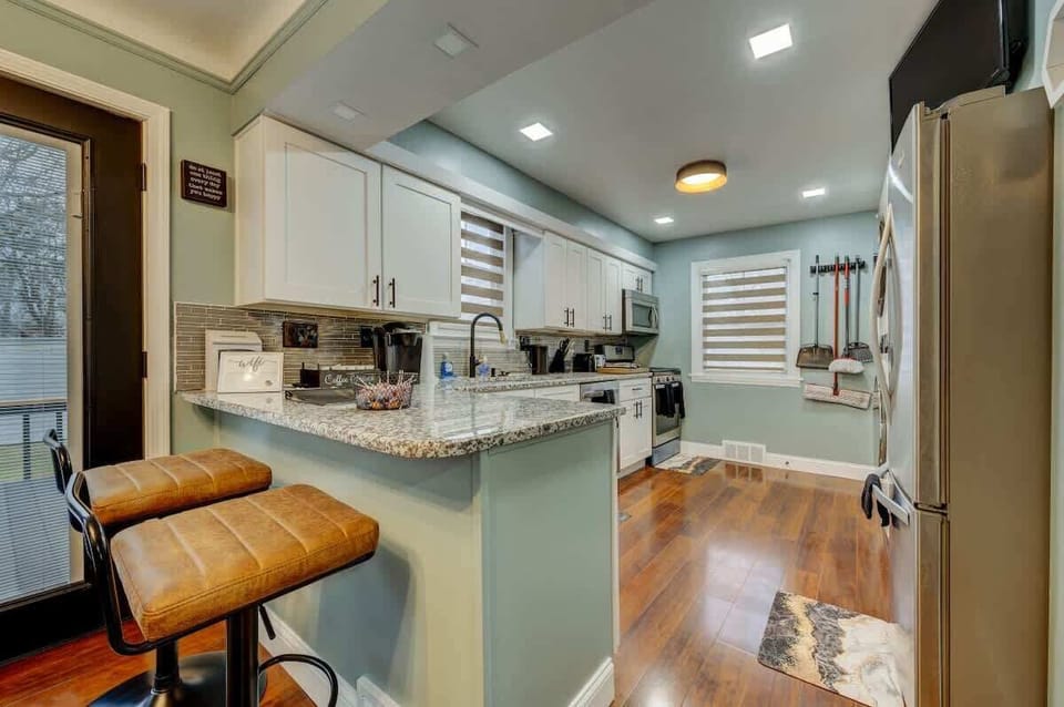 Bright kitchen w/ ample counter space, white cabinets & modern finishes