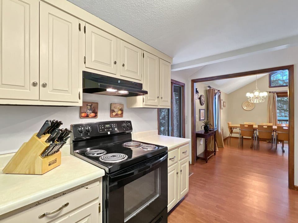 Stove and prep area with a clear view into the dining space.