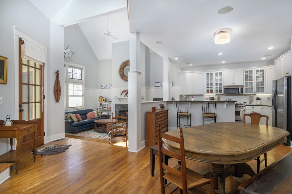 Open-concept main floor with living room, dining area, and kitchen. Note: The gas log fireplace is NOT usable.