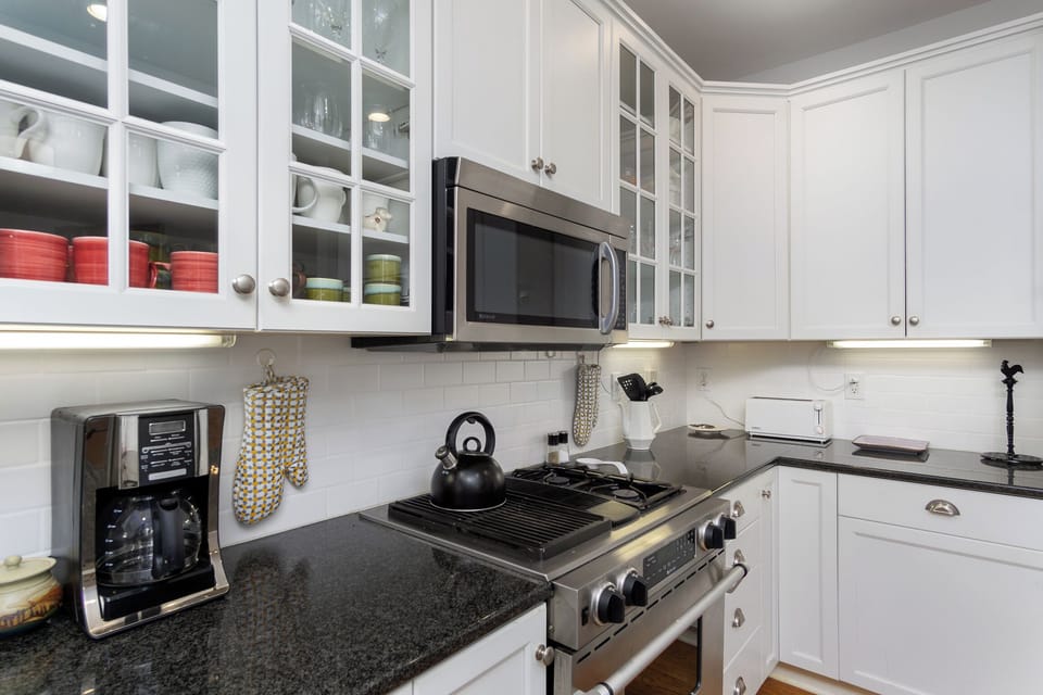 Kitchen with gas range, dishwasher, drip-style coffee maker, French press & Italian Espresso.