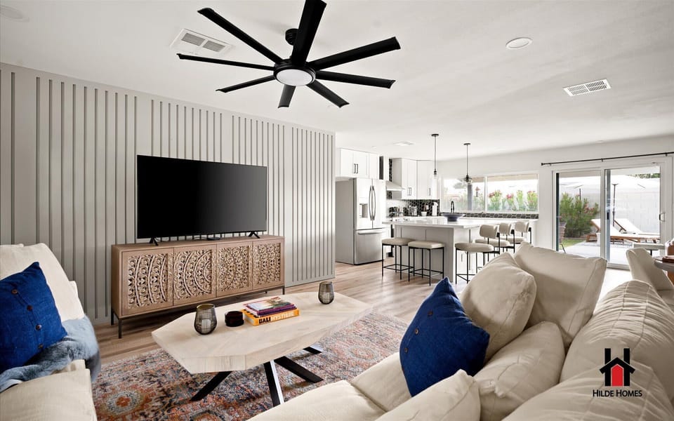 Large living room with plush sofas & a Smart TV to come together for family time