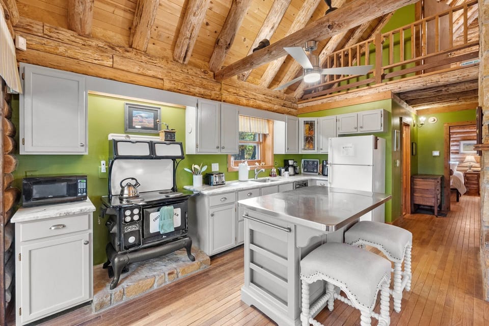 The antique kitchen oven/stovetop in this photo has been replaced with a brand-new and much more functional induction stovetop and oven.
