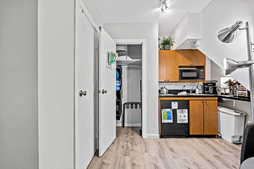 A kitchenette in comes fully stocked with basic kitchen supplies, ie: utensils, flatware, glasses, pots and pan, coffee maker, and microwave.