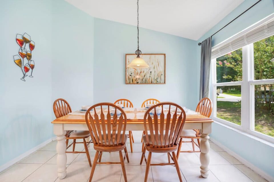 Dining area with natural light and wooden furniture in a cozy setting