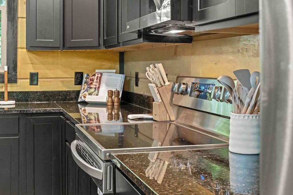 Sleek black cabinetry pairs with granite counters for a stylish cooking adventure!