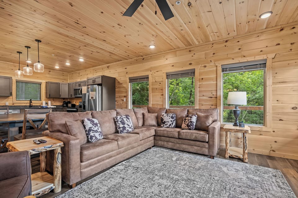 Spacious living room with queen sleeper sofa, TV, & fireplace
