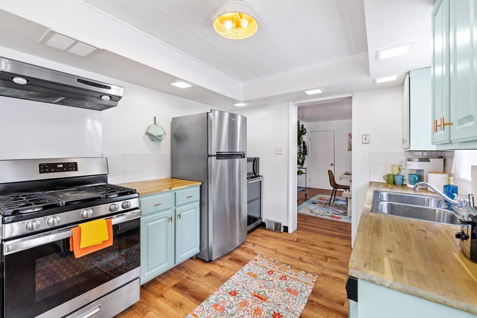 fully equipped kitchen with hardwood floors and modern appliances