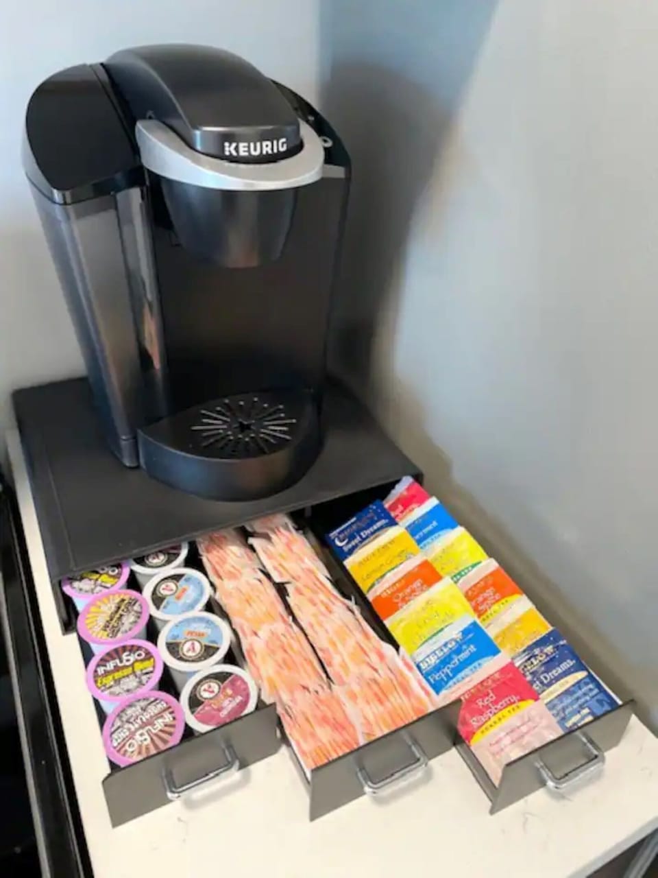Keurig machine with coffee pods, sugar, creamer and teas included. 